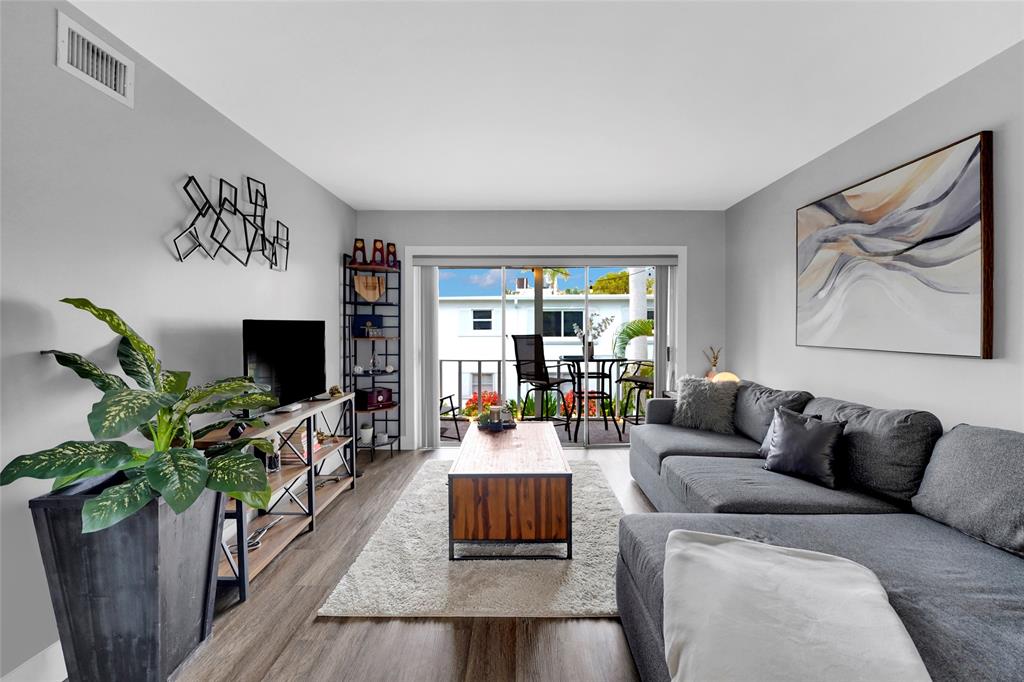 2161 Northeast 42nd Court, Unit 215 Lighthouse Point, FL 33064 - Photo 6 of 50 a living room with furniture and a flat screen tv