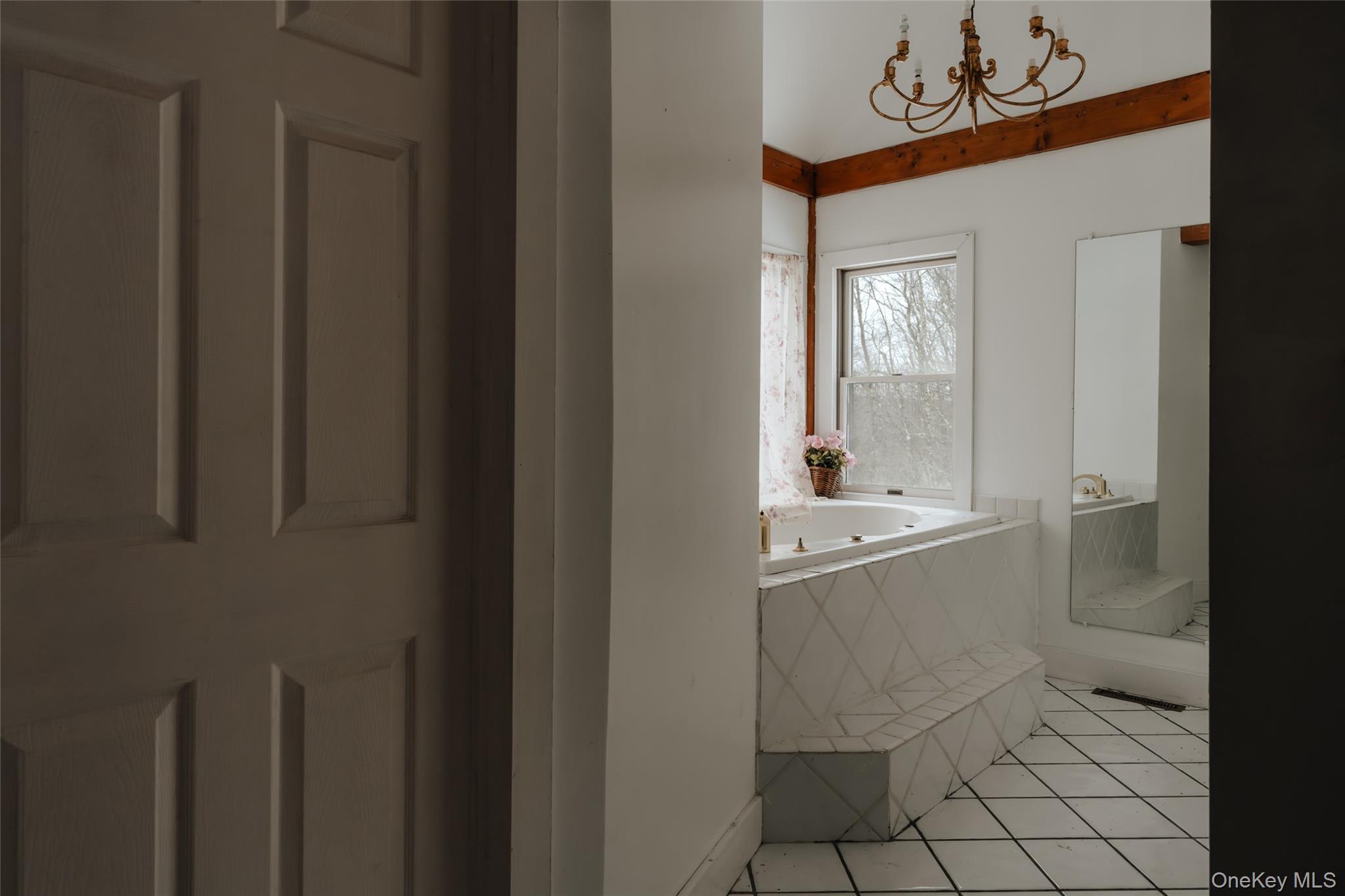 26 Beckys Hill Road Loch Sheldrake, NY 12759 - Photo 29 of 50 Full bathroom featuring a garden tub, tile patterned floors, and a chandelier