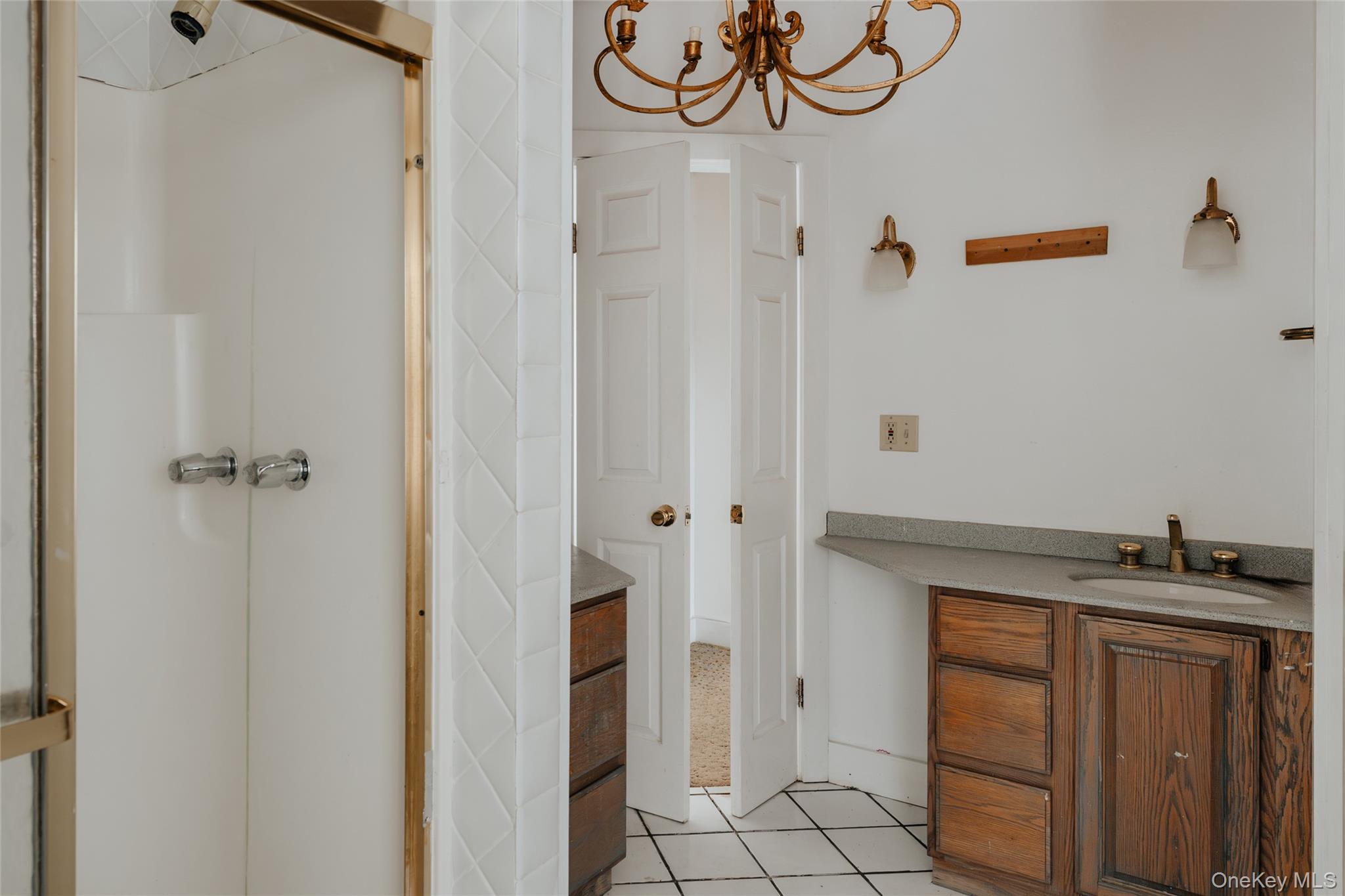 26 Beckys Hill Road Loch Sheldrake, NY 12759 - Photo 32 of 50 Bathroom featuring vanity, a shower stall, light tile patterned floors, and a chandelier