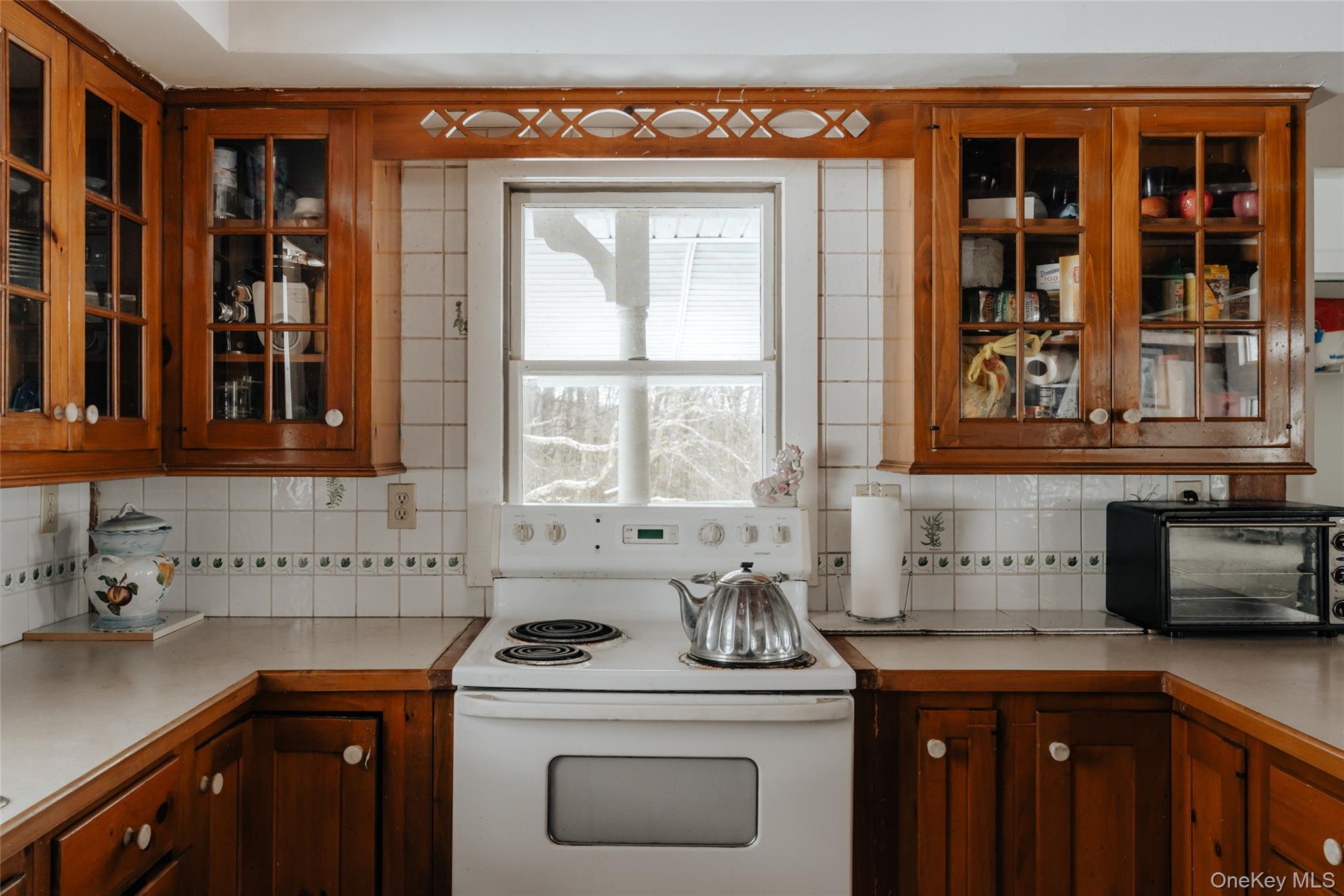 26 Beckys Hill Road Loch Sheldrake, NY 12759 - Photo 34 of 50 Kitchen with glass insert cabinets, white electric stove, and light countertops