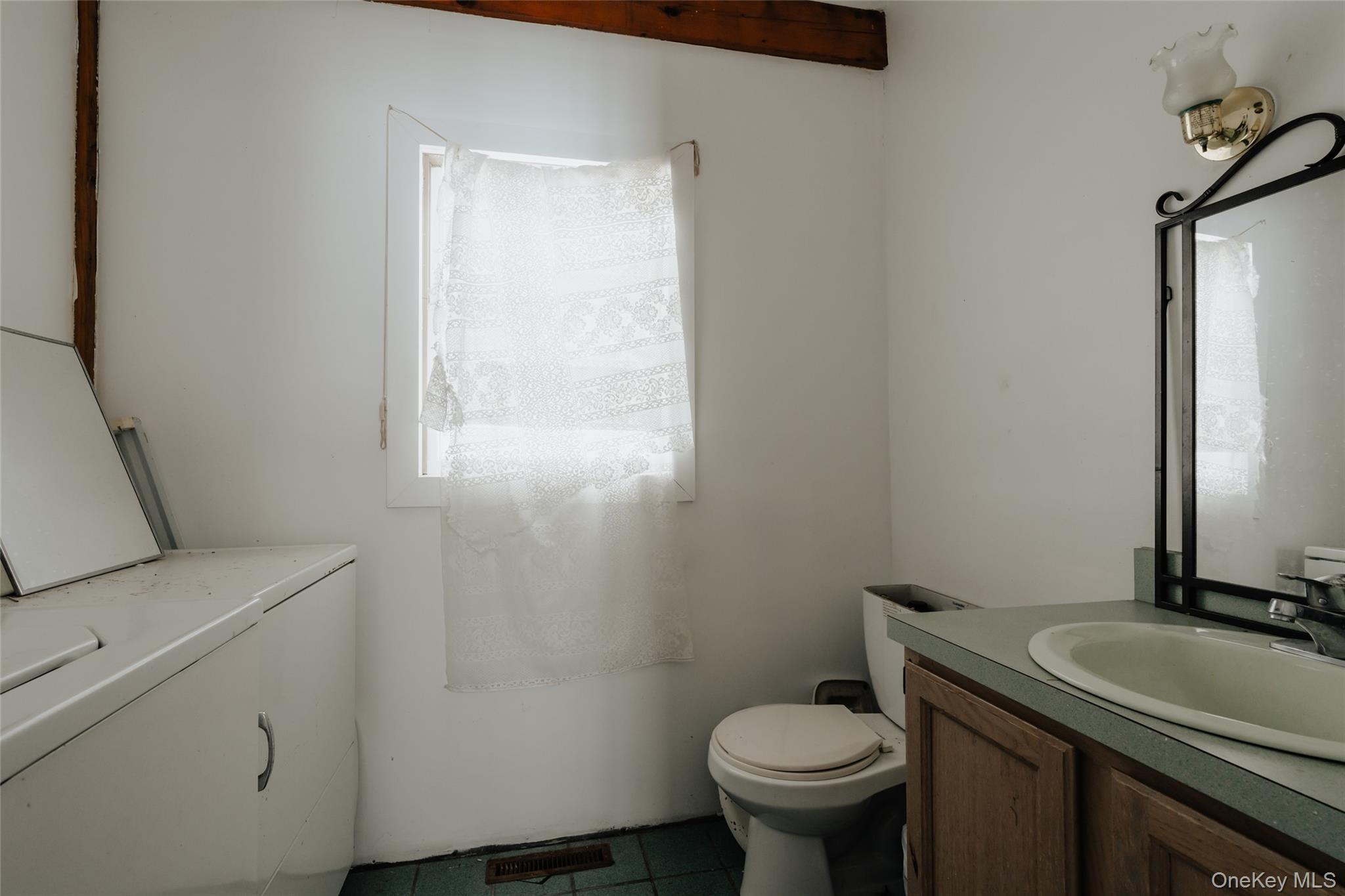 26 Beckys Hill Road Loch Sheldrake, NY 12759 - Photo 36 of 50 Half bath with vanity, washer / dryer, and tile patterned flooring