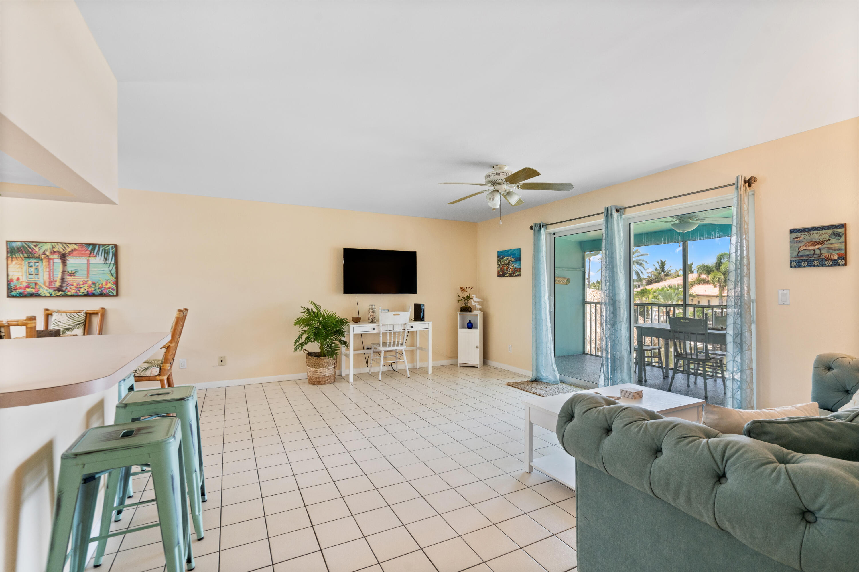 249 Center Street, Unit 2C Jupiter, FL 33458 - Photo 11 of 29 a living room with furniture and a flat screen tv