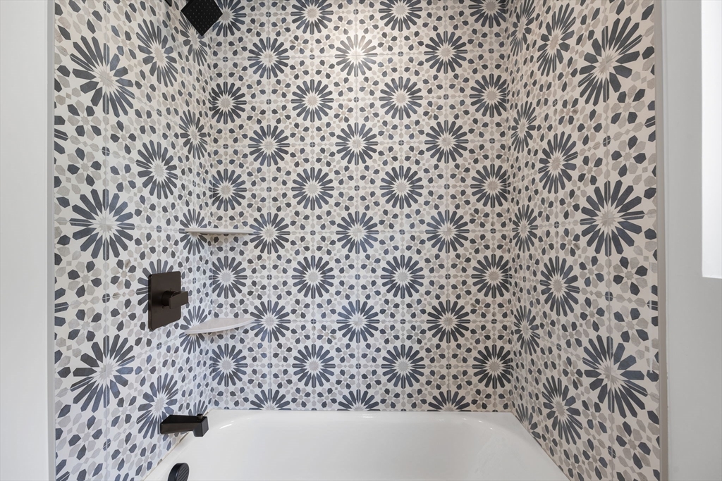 148 Myrtle Street, Unit 4 Melrose, MA 02176 - Photo 13 of 35 a bathroom with a shower curtain