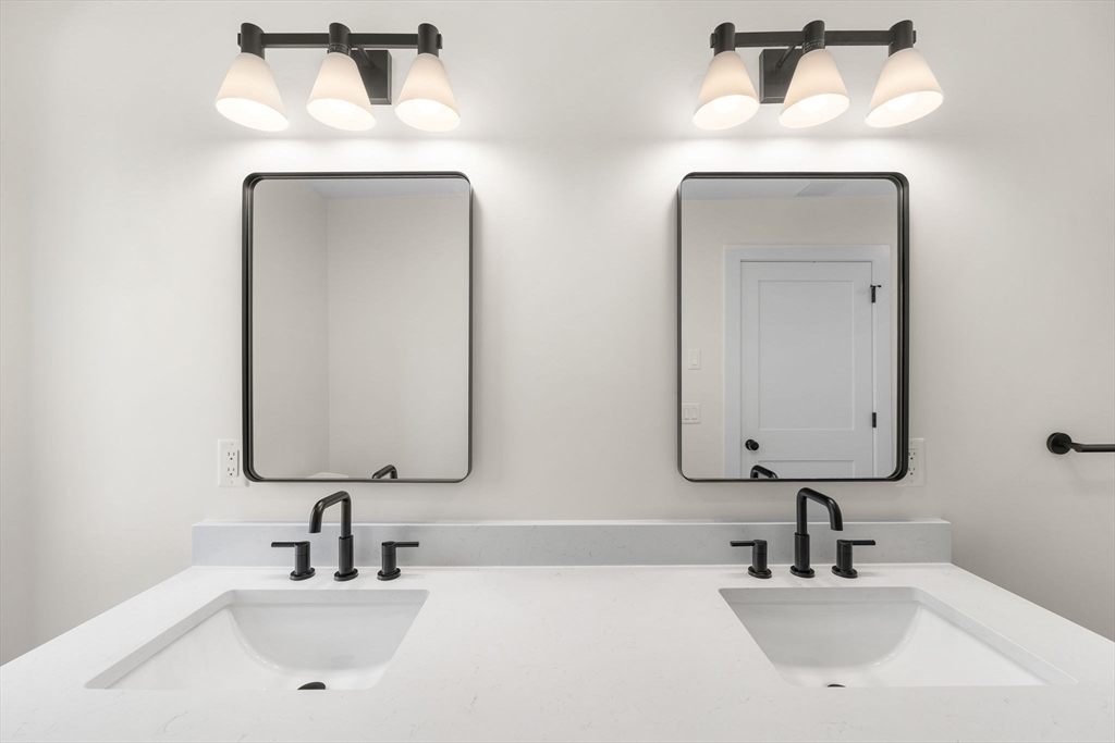 148 Myrtle Street, Unit 4 Melrose, MA 02176 - Photo 14 of 35 a bathroom with double vanity sinks and two mirror