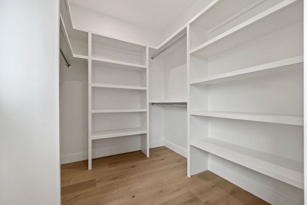 148 Myrtle Street, Unit 4 Melrose, MA 02176 - Photo 24 of 35 a view of walk in closet with empty racks