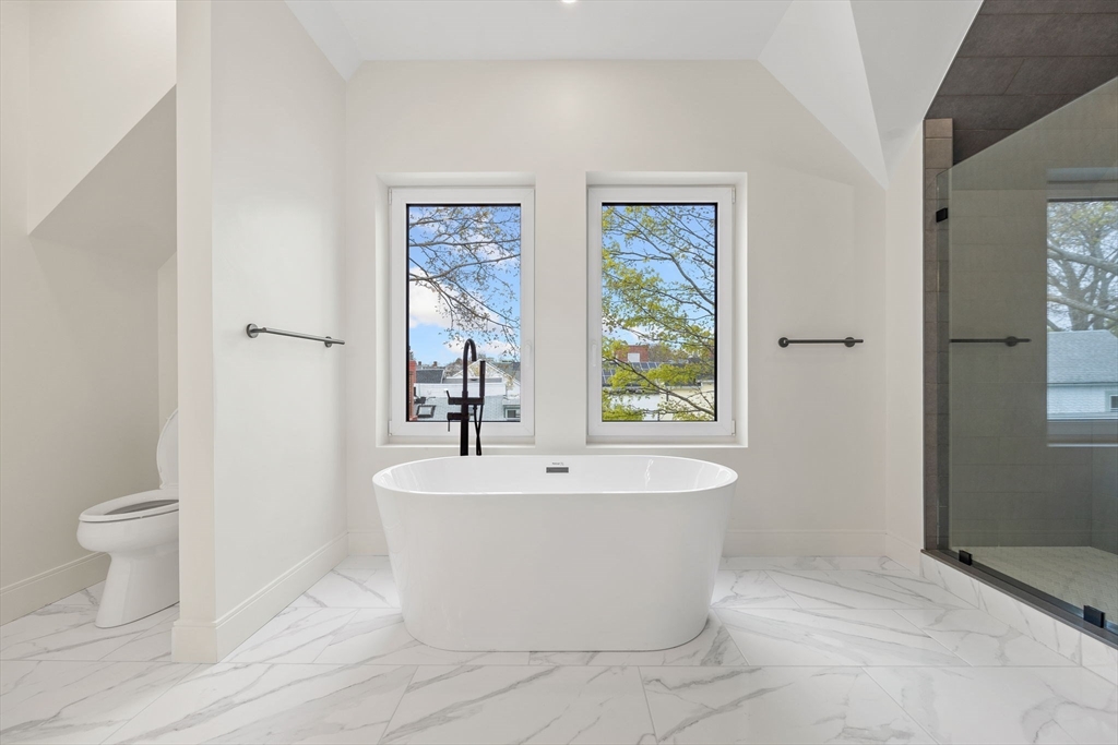 148 Myrtle Street, Unit 4 Melrose, MA 02176 - Photo 26 of 35 a white bath tub sitting next to a white toilet