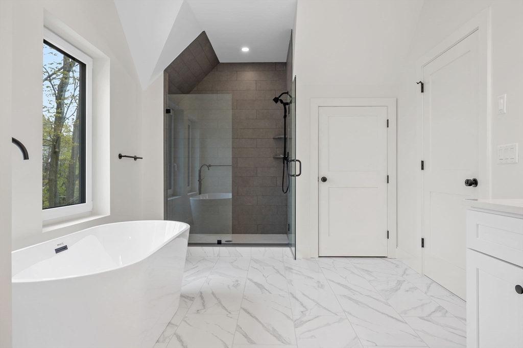 148 Myrtle Street, Unit 4 Melrose, MA 02176 - Photo 28 of 35 a bathroom with a bathtub and a shower