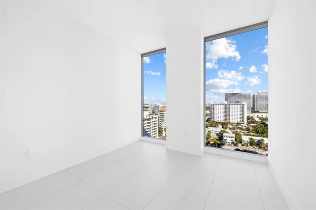 a living room with furniture kitchen view and a flat screen tv
