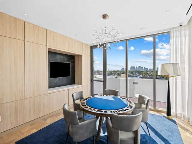 a table and chairs in a room next to a window