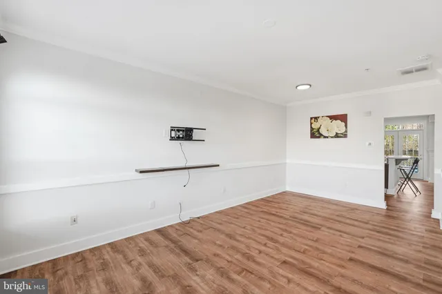 a view of a room with wooden floor