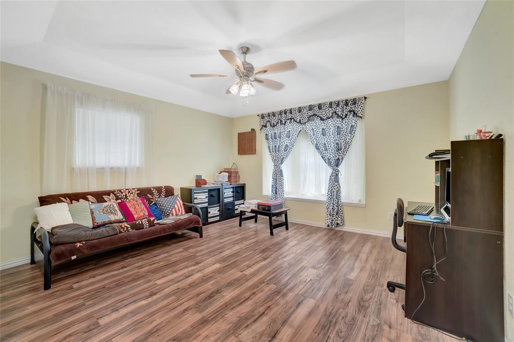 6021 Sycamore Creek Road Edgecliff Village, TX 76134 - Photo 19 of 37 Living area featuring wood finished floors, ceiling fan, baseboards, and a tray ceiling