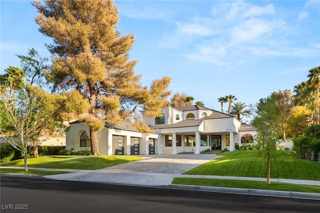 2316 Prometheus Court Henderson, NV 89074 - Photo 52 of 92 View of front of home with a front yard, driveway, and stucco siding