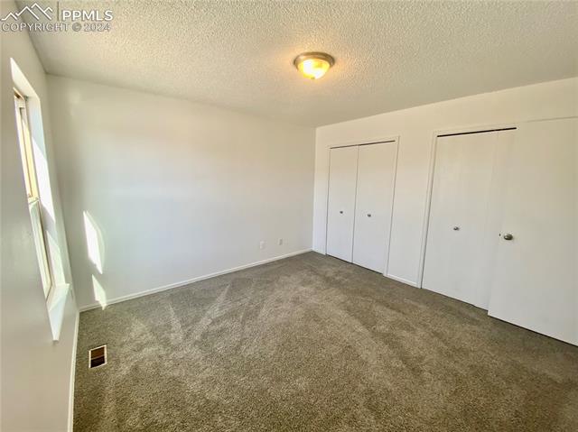 5070 Victory Road Colorado Springs, CO 80911 - Photo 2 of 9 Primary bedroom with 2 his & hers closets