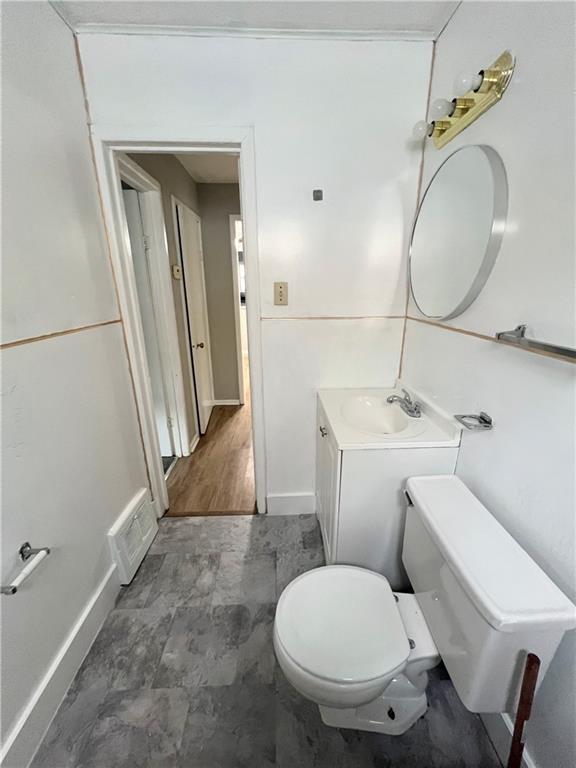 7726 Michigan Road Pittsburgh, PA 15235 - Photo 4 of 6 a bathroom with a toilet sink and mirror