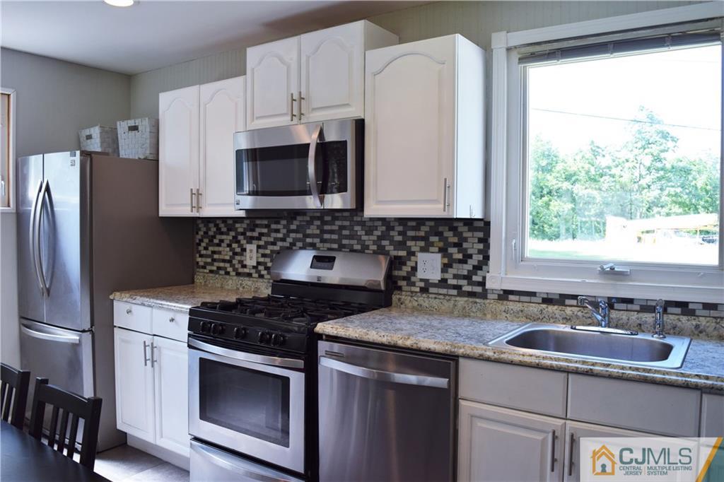 24 North Pennington Road New Brunswick, NJ 08901 - Photo 15 of 47 a kitchen with granite countertop a sink stove and refrigerator