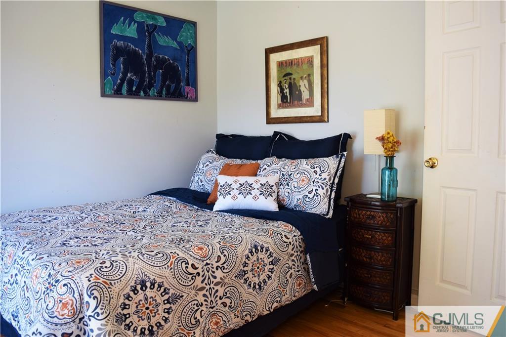 24 North Pennington Road New Brunswick, NJ 08901 - Photo 21 of 47 a bedroom with a bed and wooden floor