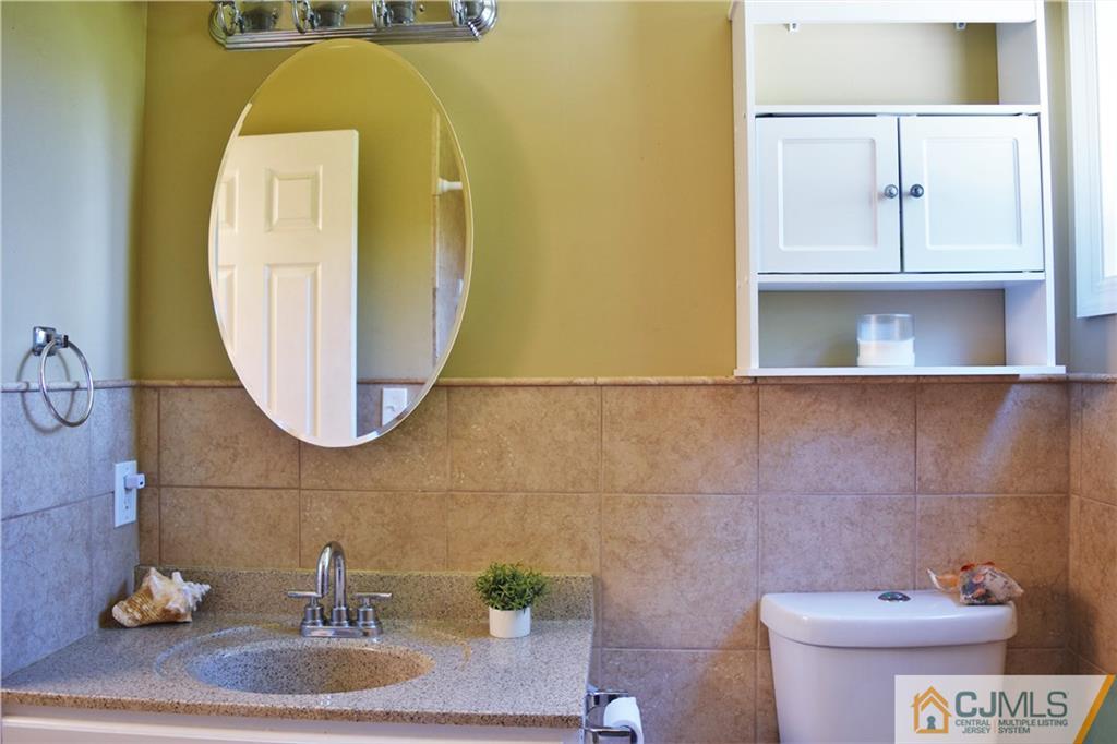 24 North Pennington Road New Brunswick, NJ 08901 - Photo 24 of 47 a bathroom with a sink and a mirror