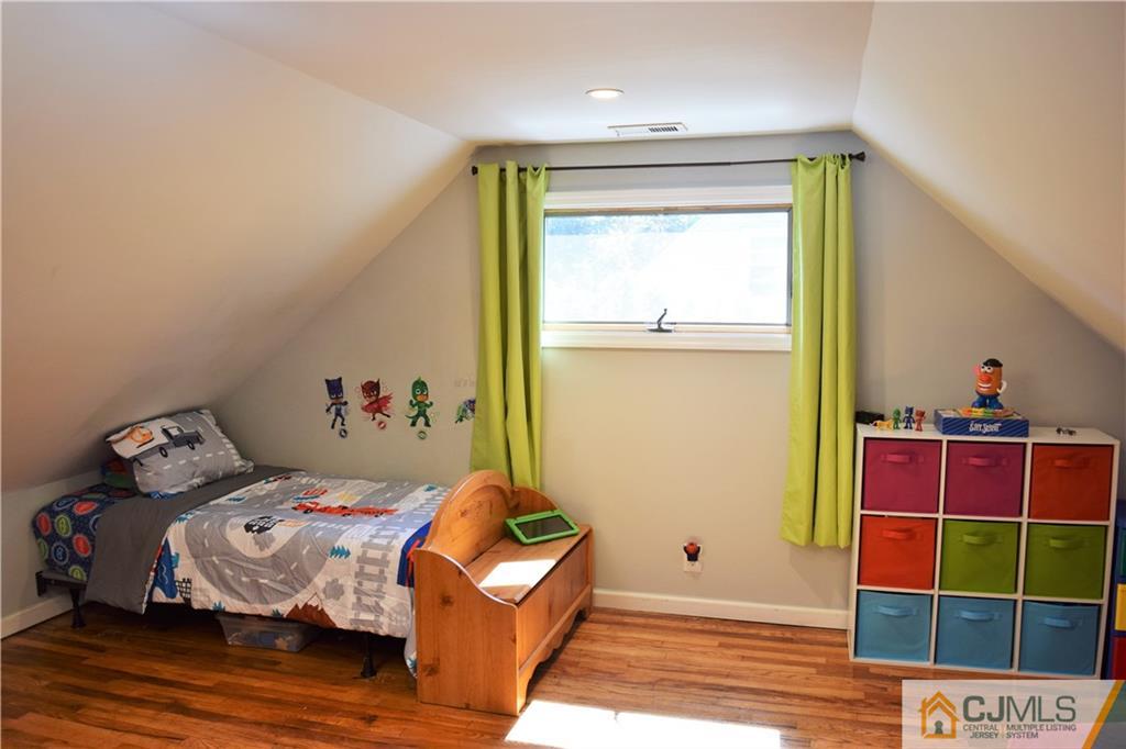 24 North Pennington Road New Brunswick, NJ 08901 - Photo 27 of 47 a bedroom with a bed and a window