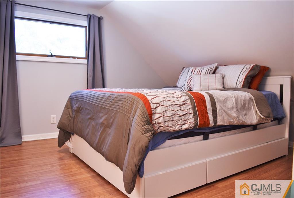 24 North Pennington Road New Brunswick, NJ 08901 - Photo 34 of 47 a bedroom with a bed and window