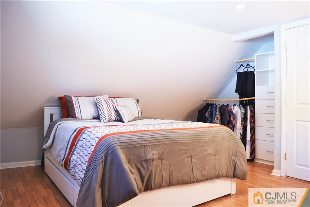 24 North Pennington Road New Brunswick, NJ 08901 - Photo 35 of 47 a bedroom with a bed and wooden floor