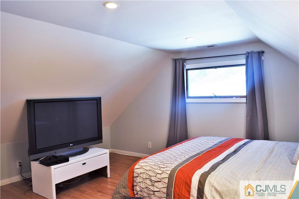 24 North Pennington Road New Brunswick, NJ 08901 - Photo 36 of 47 a bedroom with a bed and television