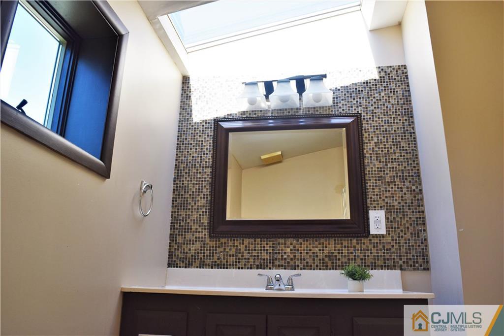 24 North Pennington Road New Brunswick, NJ 08901 - Photo 38 of 47 a bathroom with a sink and a mirror