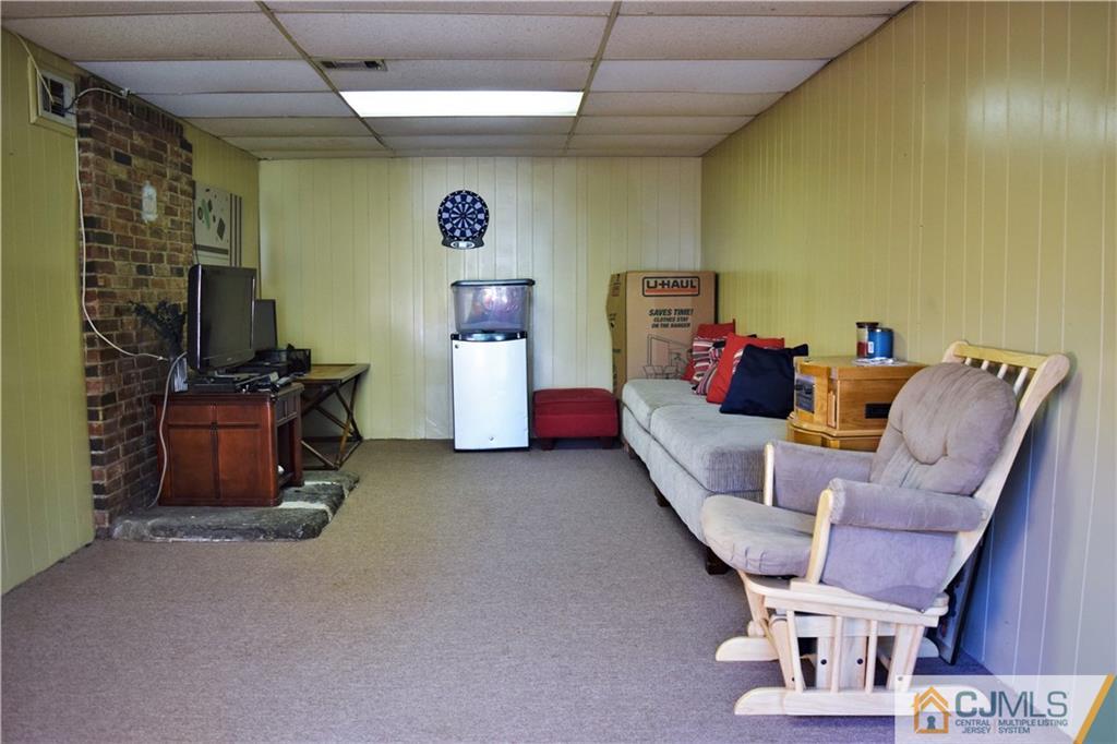 24 North Pennington Road New Brunswick, NJ 08901 - Photo 39 of 47 a living room with furniture and a flat screen tv