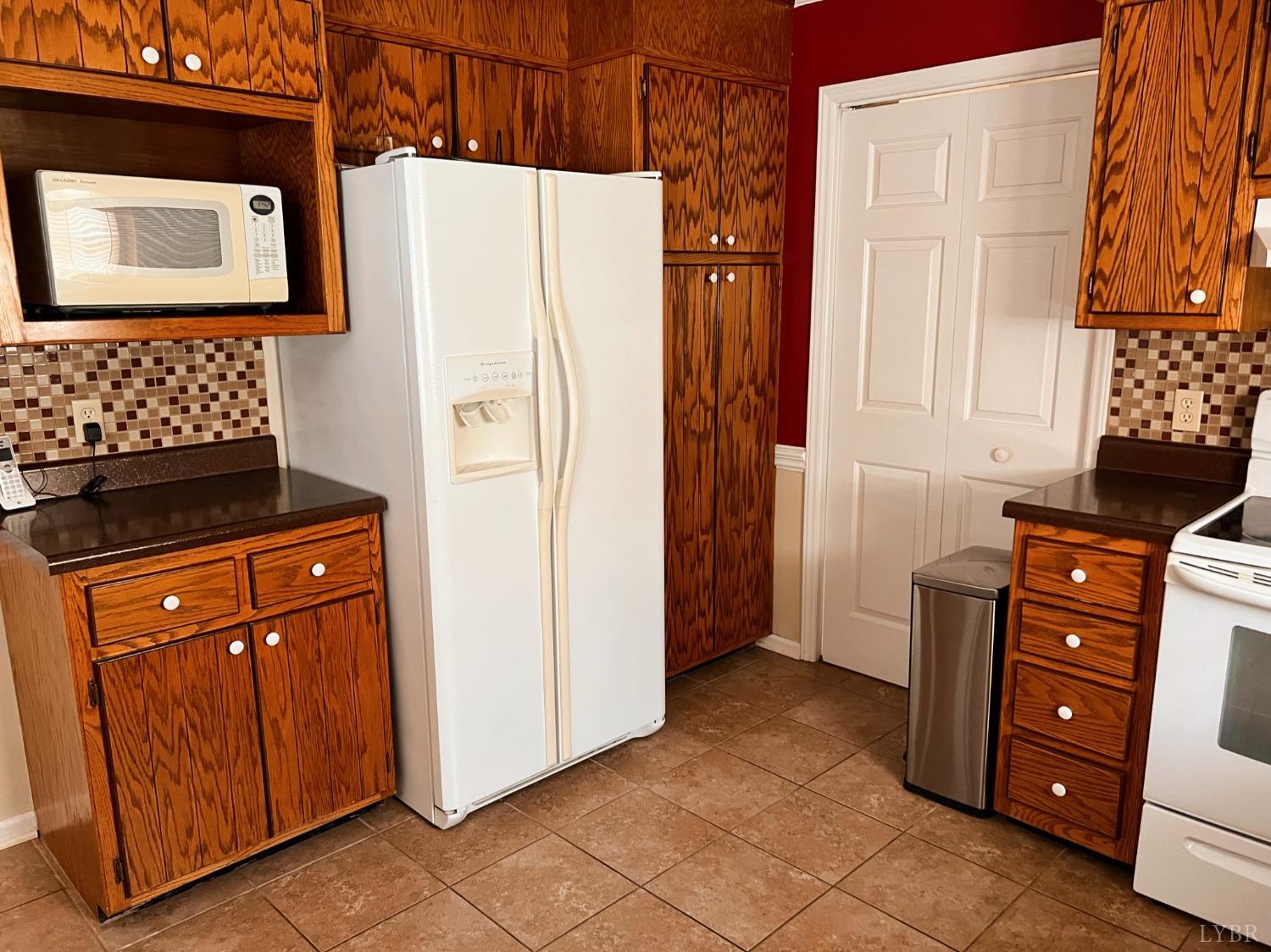 1009 Fall Creek Road Ringgold, VA 24586 - Photo 13 of 58 a kitchen with stainless steel appliances granite countertop a refrigerator and a stove