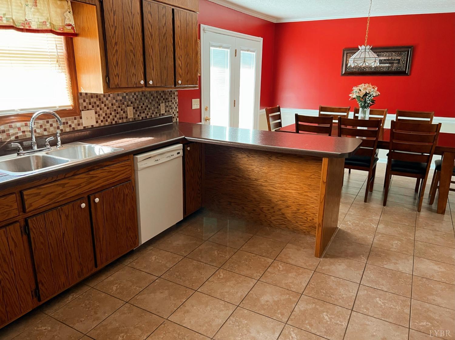 1009 Fall Creek Road Ringgold, VA 24586 - Photo 14 of 58 a kitchen with stainless steel appliances a sink cabinets and a dining table