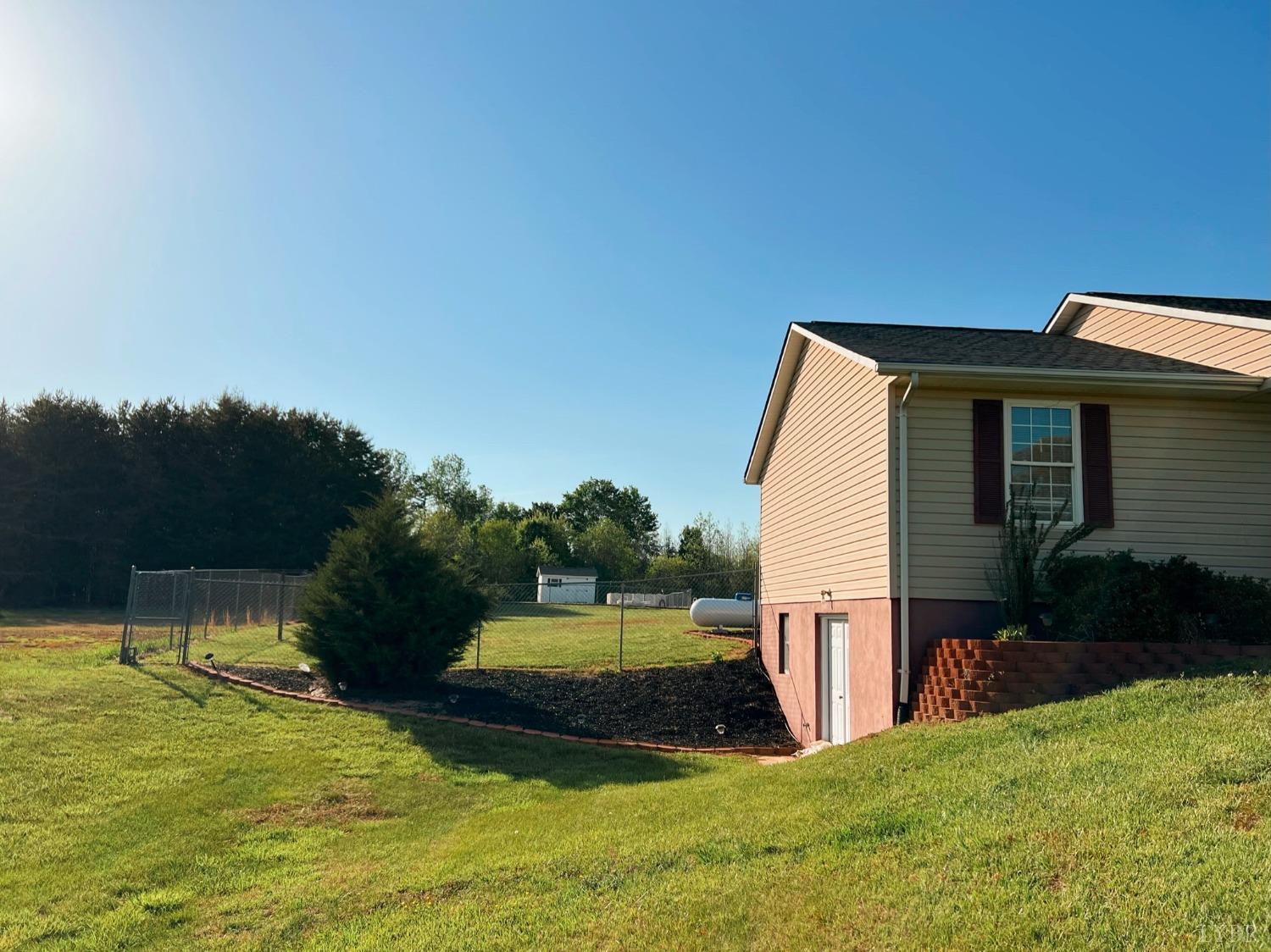 1009 Fall Creek Road Ringgold, VA 24586 - Photo 33 of 58 a view of a house with backyard and a tree