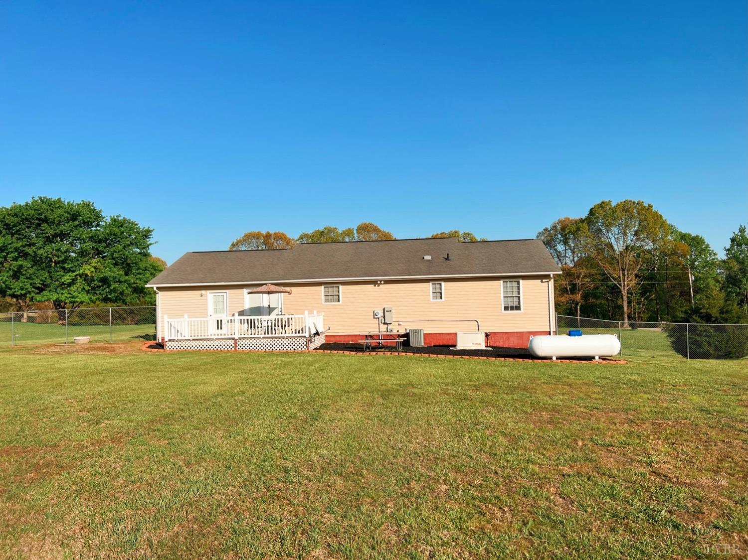 1009 Fall Creek Road Ringgold, VA 24586 - Photo 5 of 58 a view of a house with a yard and a large tree