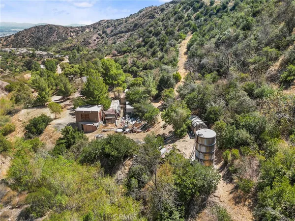 an aerial view of a house with a yard