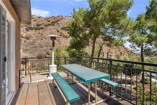 a view of balcony with wooden floor and fence