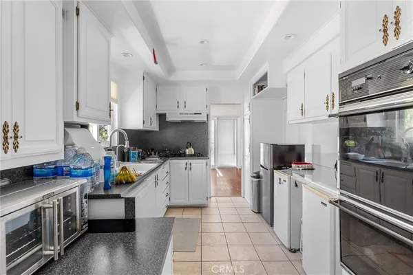a kitchen with a sink appliances and cabinets