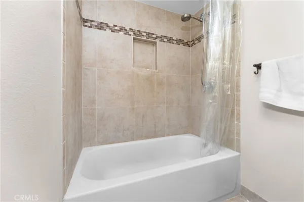 a bathroom with a shower and a bath tub