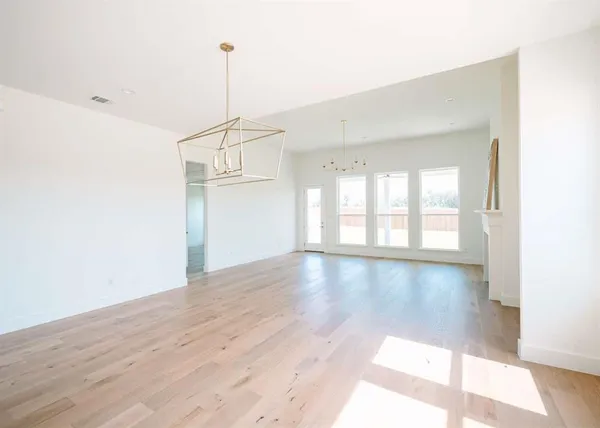 a view of a room with wooden floor and windows