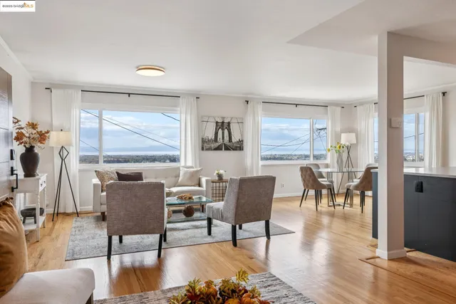 a dining room with furniture wooden floor a rug and a painting