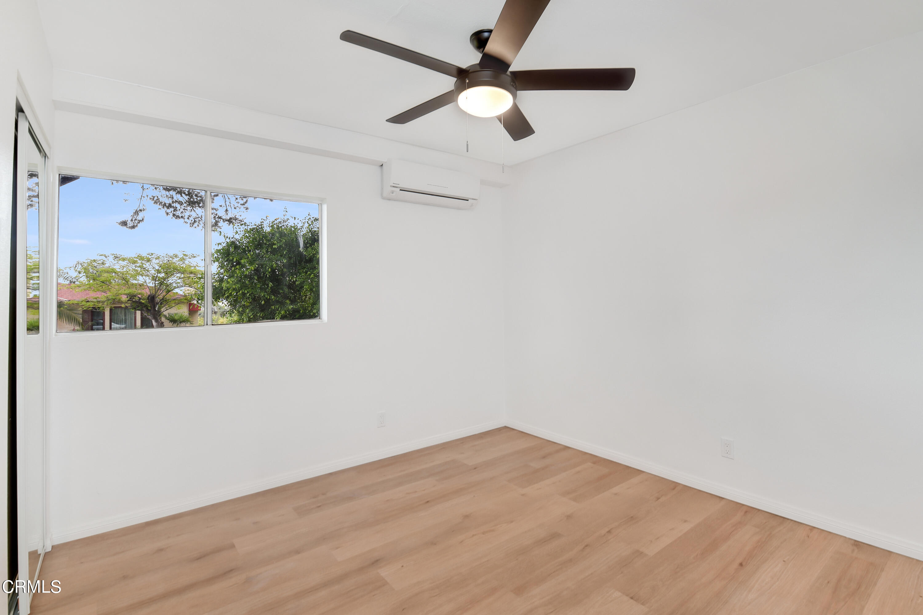 296 Foothill Drive Fillmore, CA 93015 - Photo 11 of 17 an empty room with wooden floor fan and windows