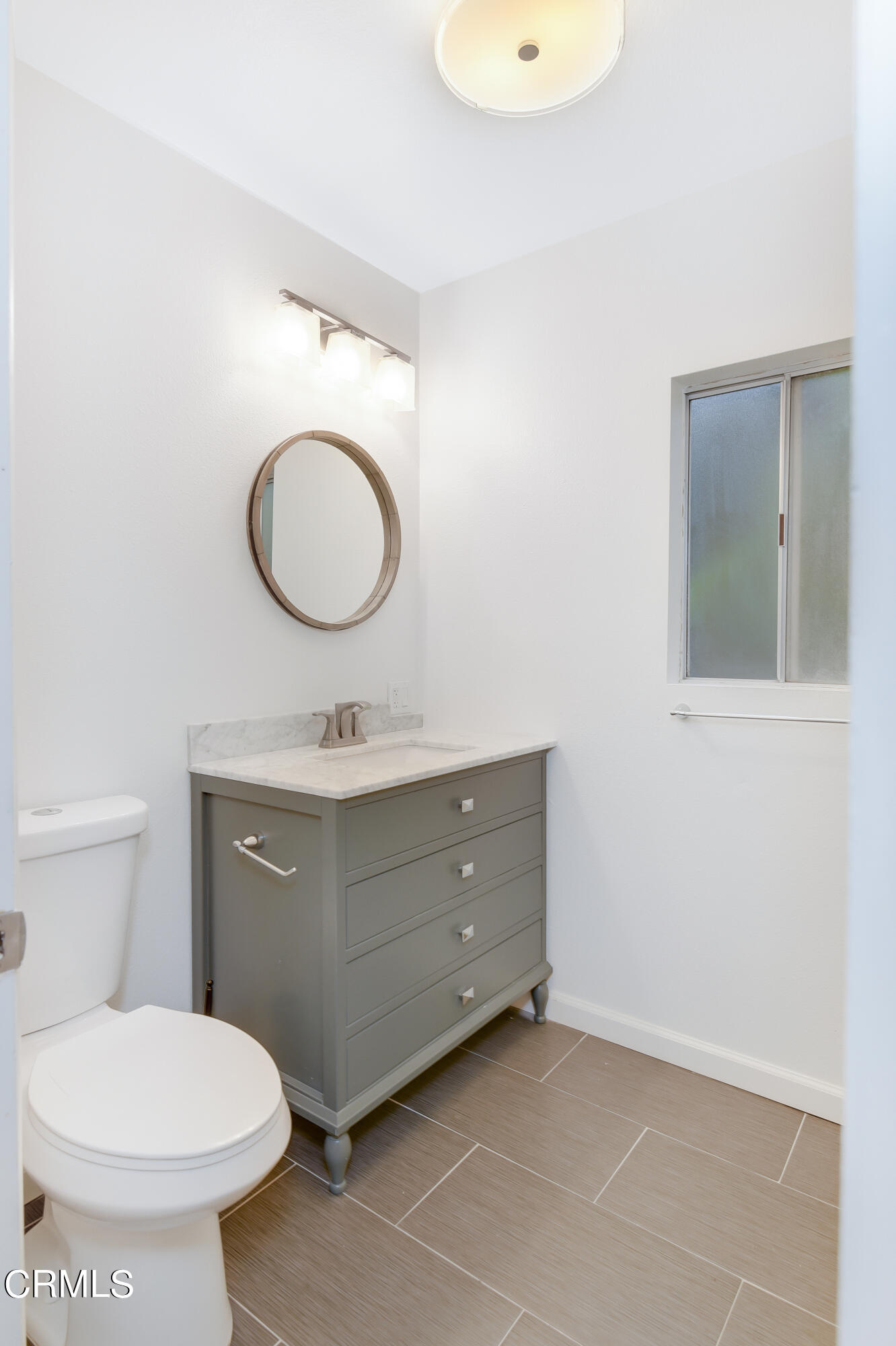 296 Foothill Drive Fillmore, CA 93015 - Photo 16 of 17 a bathroom with a toilet sink mirror and vanity