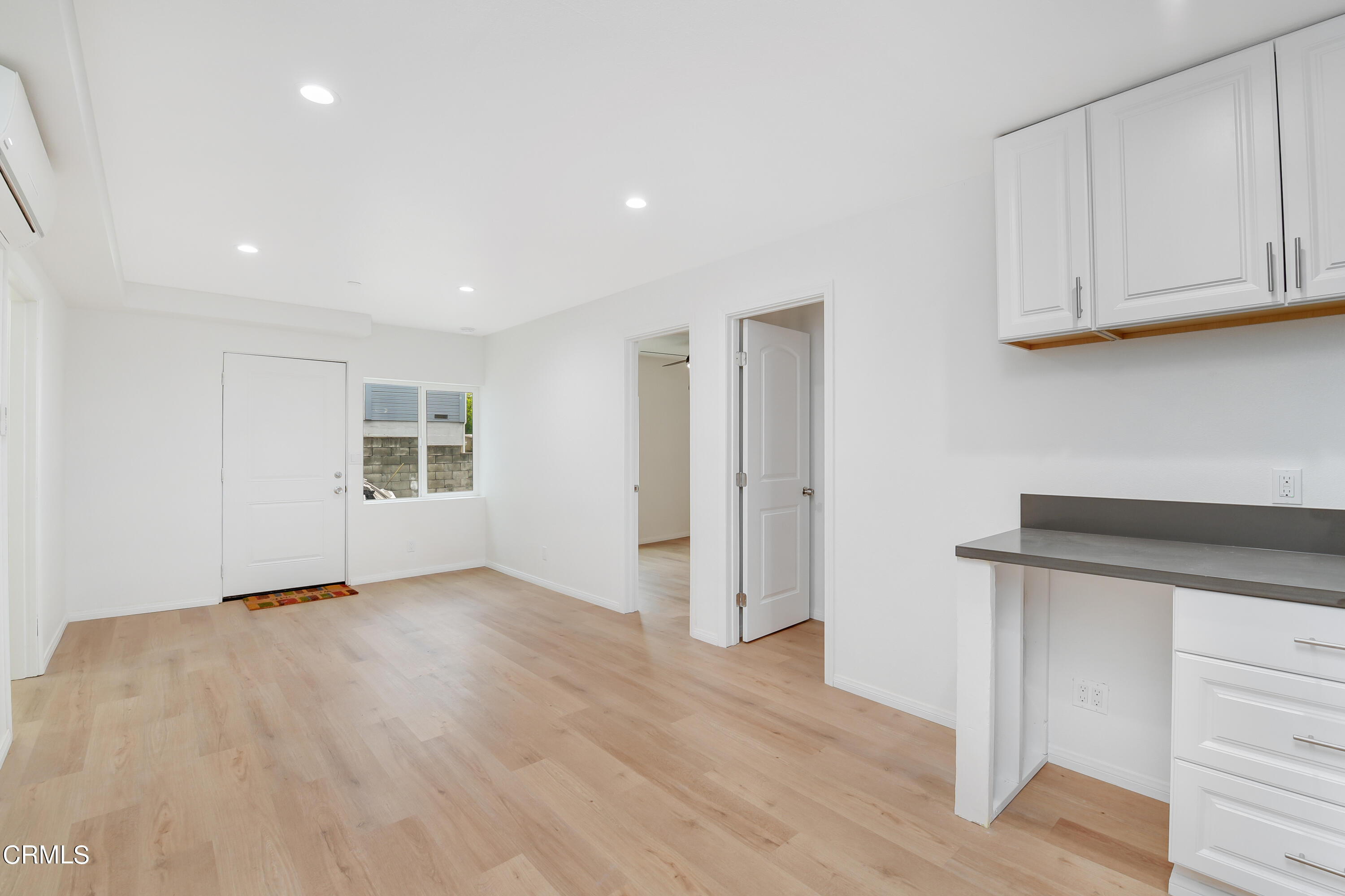 296 Foothill Drive Fillmore, CA 93015 - Photo 9 of 17 a view of an empty room with wooden floor and cabinets