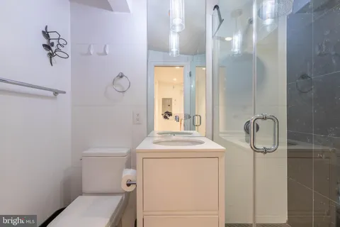 a bathroom with a toilet a sink and a mirror