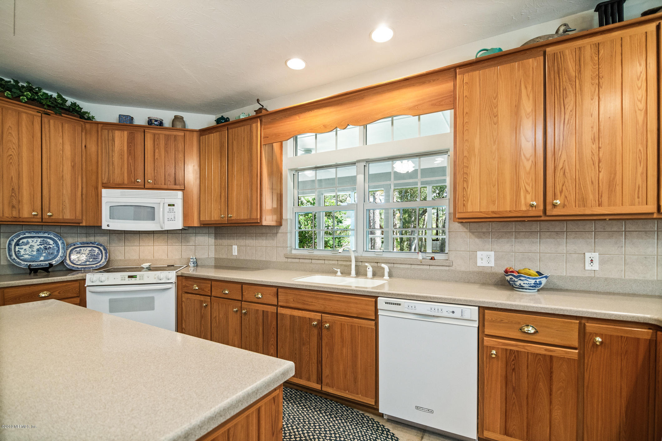 1435 Scott Road St. Johns, FL 32259 - Photo 15 of 65 a kitchen with a window a sink and cabinets