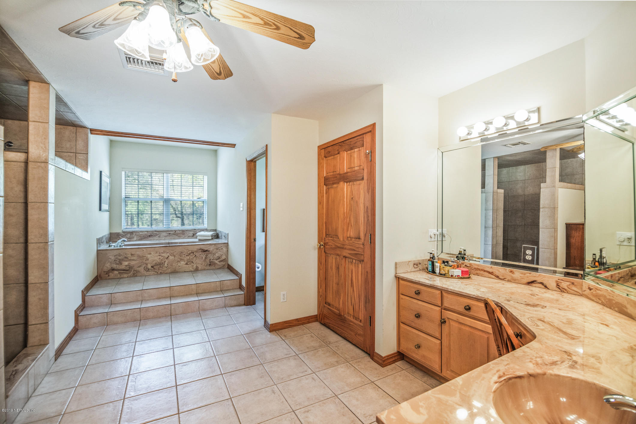 1435 Scott Road St. Johns, FL 32259 - Photo 21 of 65 a spacious bathroom with a double vanity sink a mirror and a bathtub