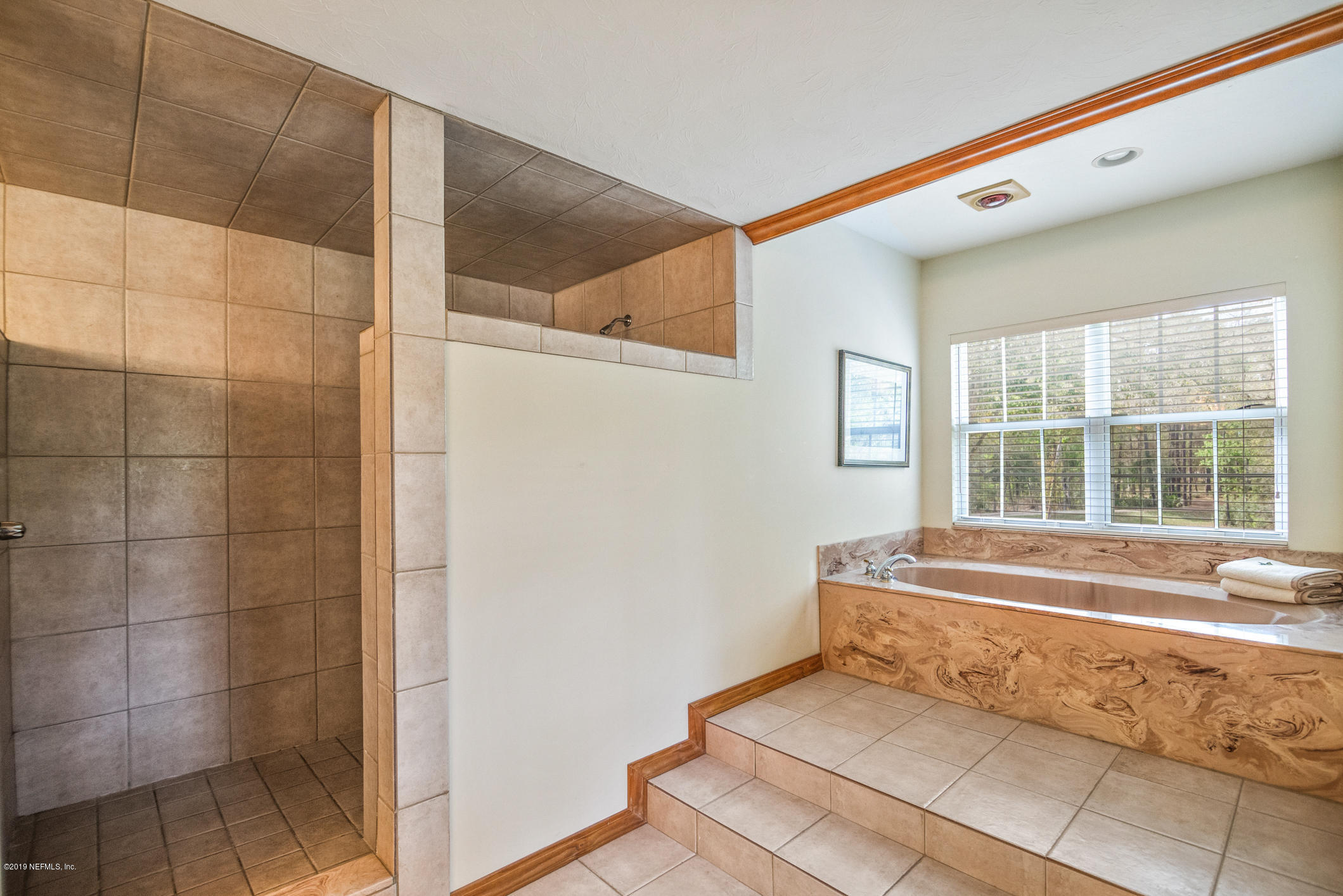 1435 Scott Road St. Johns, FL 32259 - Photo 22 of 65 a bathroom with a bathtub and next to a window