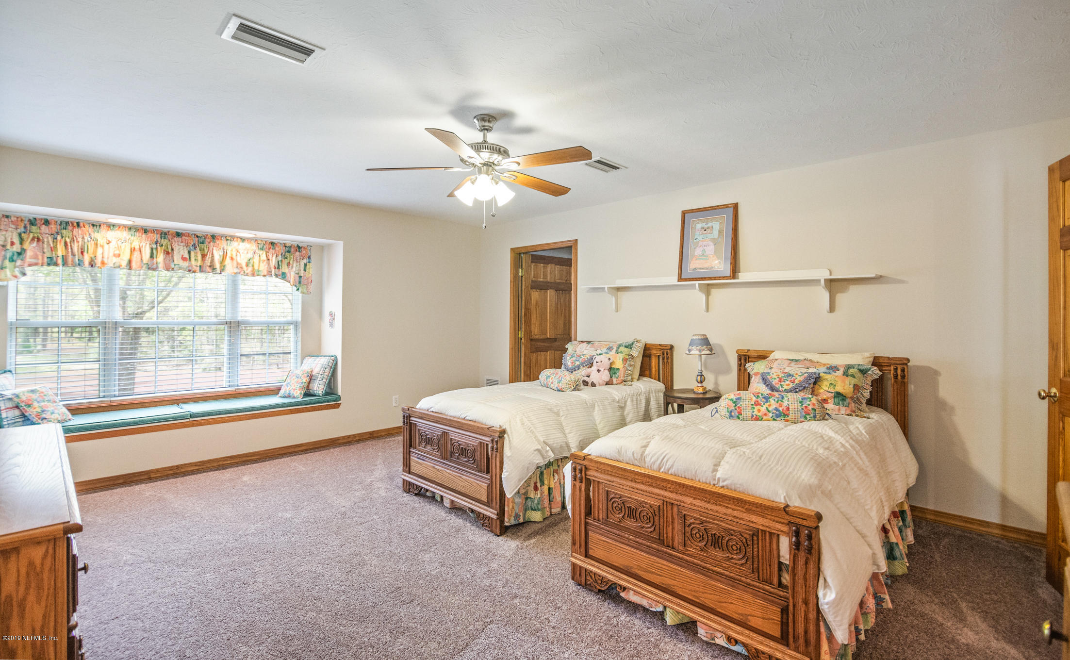 1435 Scott Road St. Johns, FL 32259 - Photo 26 of 65 a spacious bedroom with two beds and a chandelier