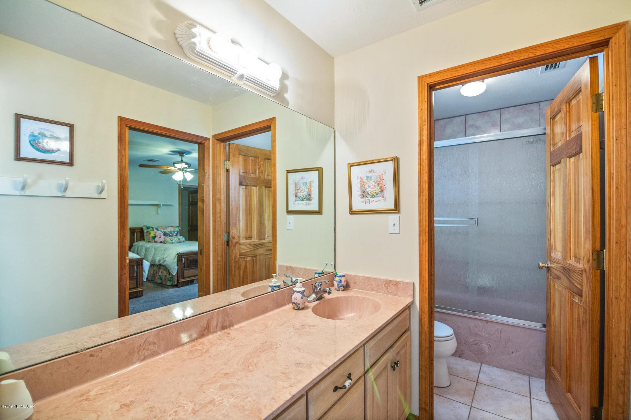 1435 Scott Road St. Johns, FL 32259 - Photo 27 of 65 a bathroom with a granite countertop sink and a mirror