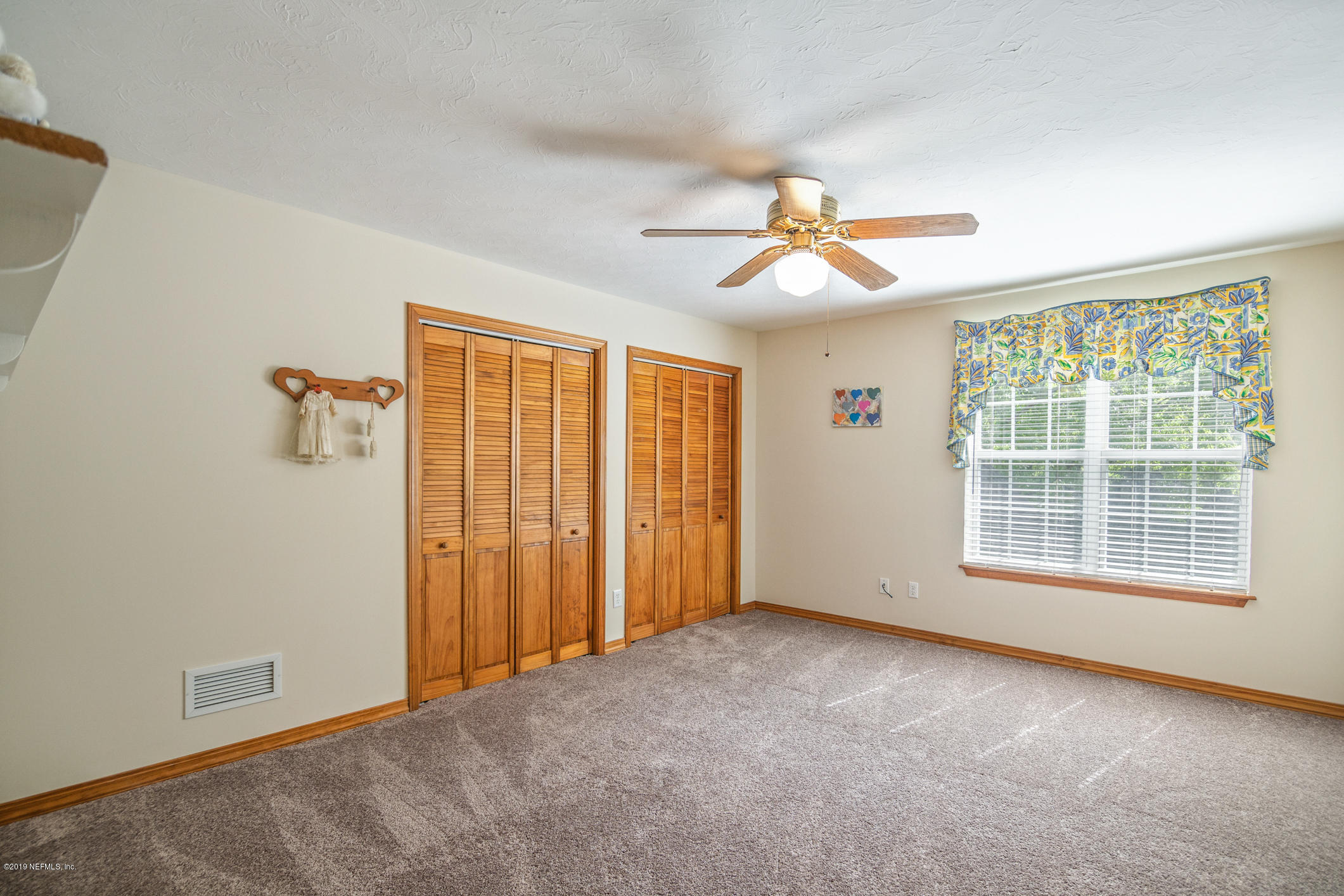 1435 Scott Road St. Johns, FL 32259 - Photo 28 of 65 an empty room with chandelier fan and windows
