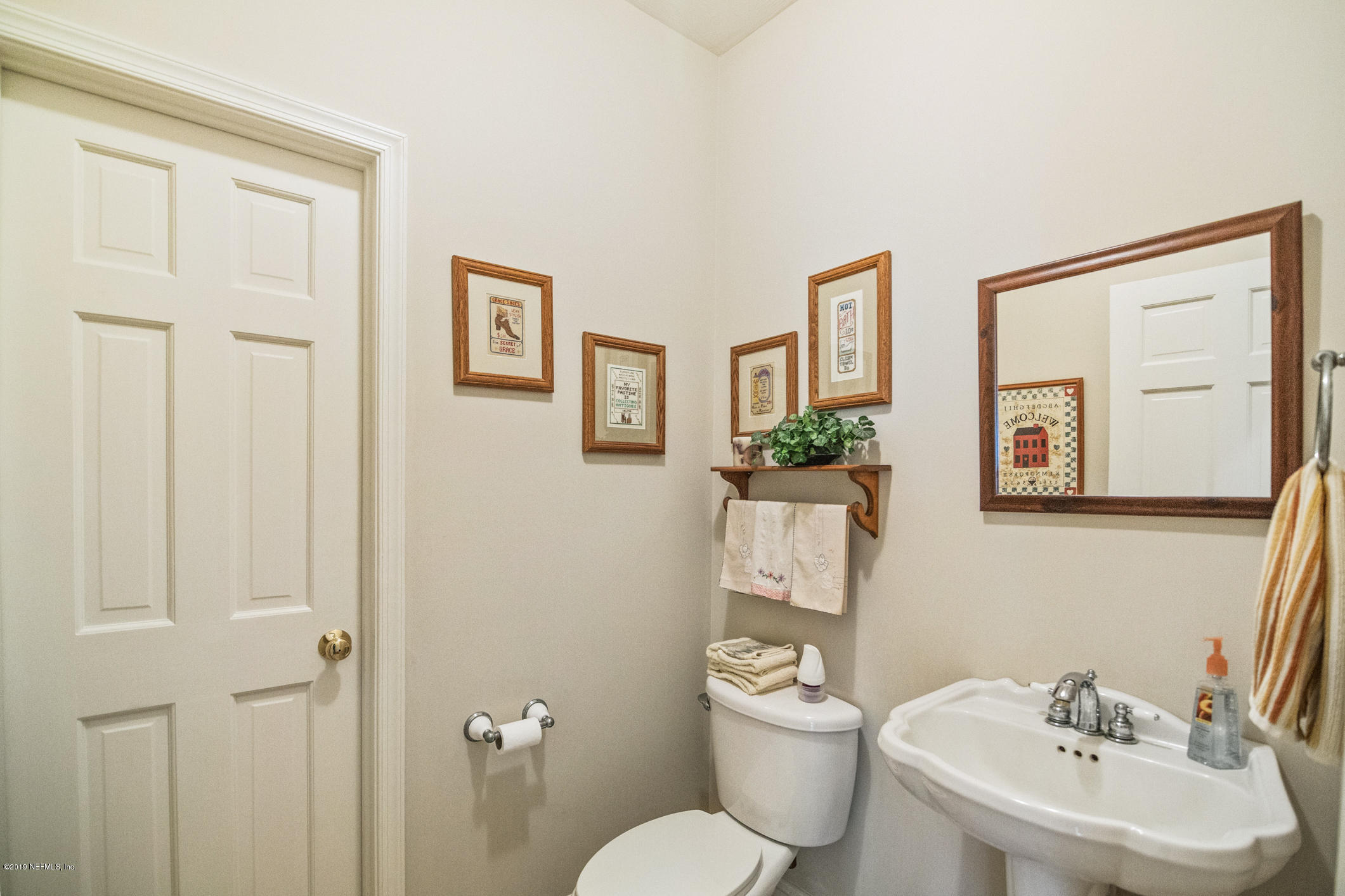 1435 Scott Road St. Johns, FL 32259 - Photo 31 of 65 a bathroom with a toilet a sink and mirror