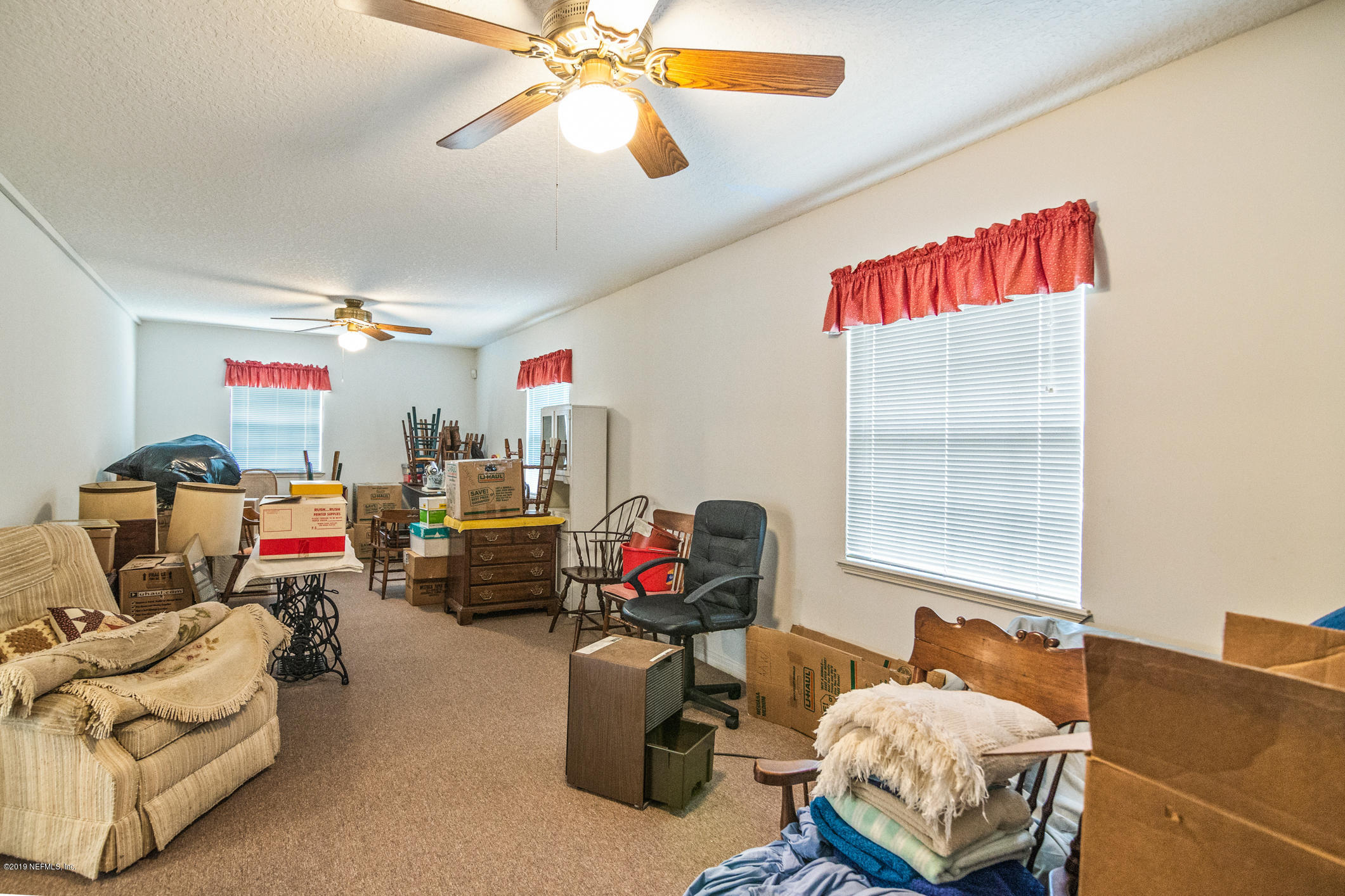 1435 Scott Road St. Johns, FL 32259 - Photo 44 of 65 a living room with furniture and a flat screen tv
