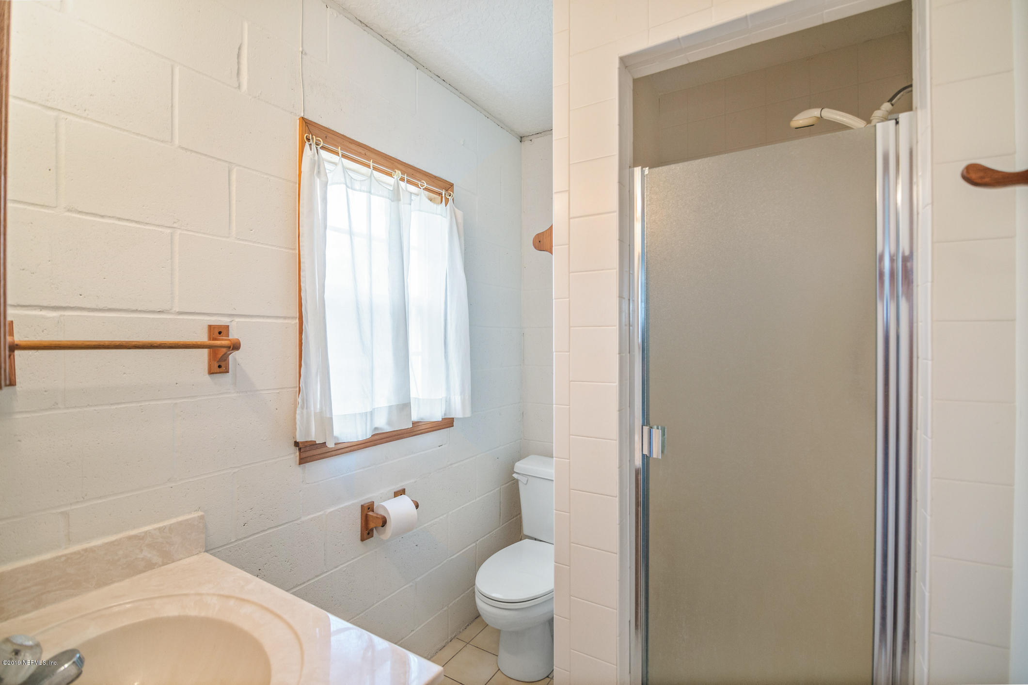1435 Scott Road St. Johns, FL 32259 - Photo 45 of 65 a bathroom with a toilet a sink and a mirror